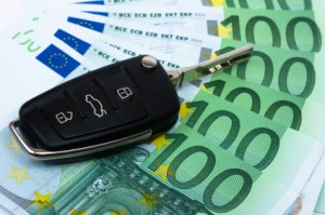 Car key on money background.